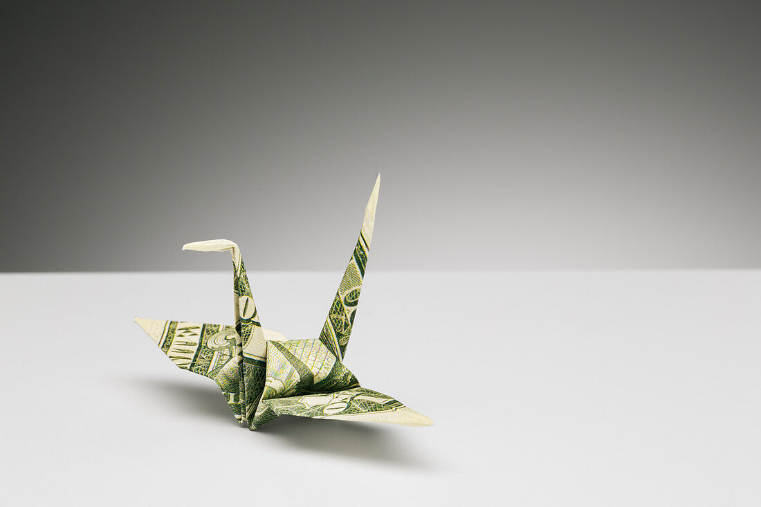 Origami crane made of dollar bill