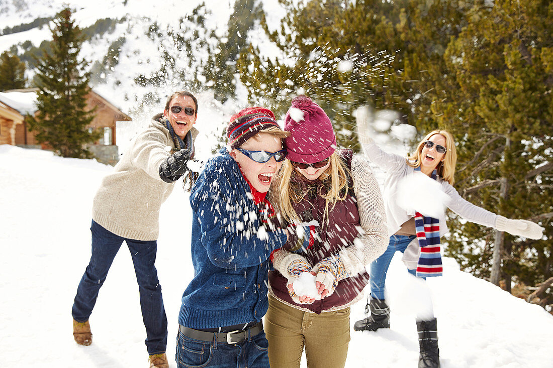 Family having snowball fight together