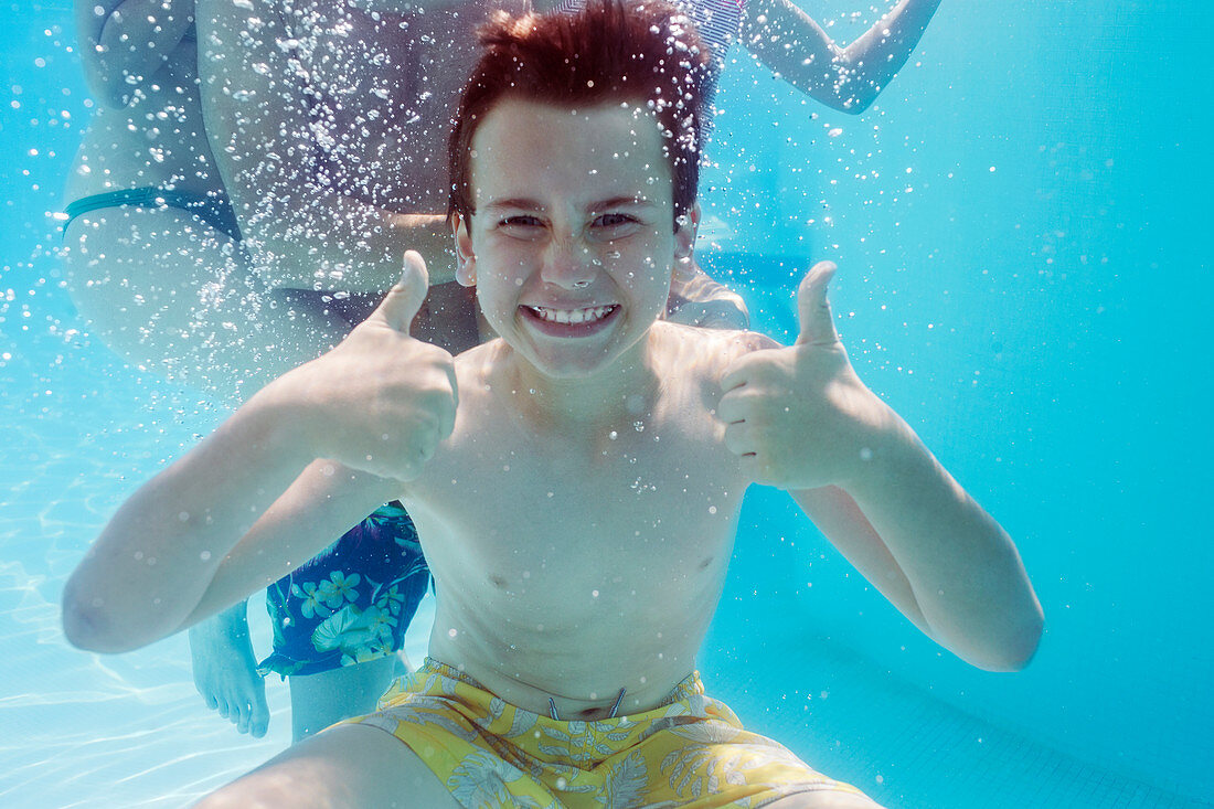 Boy with thumbs up underwater