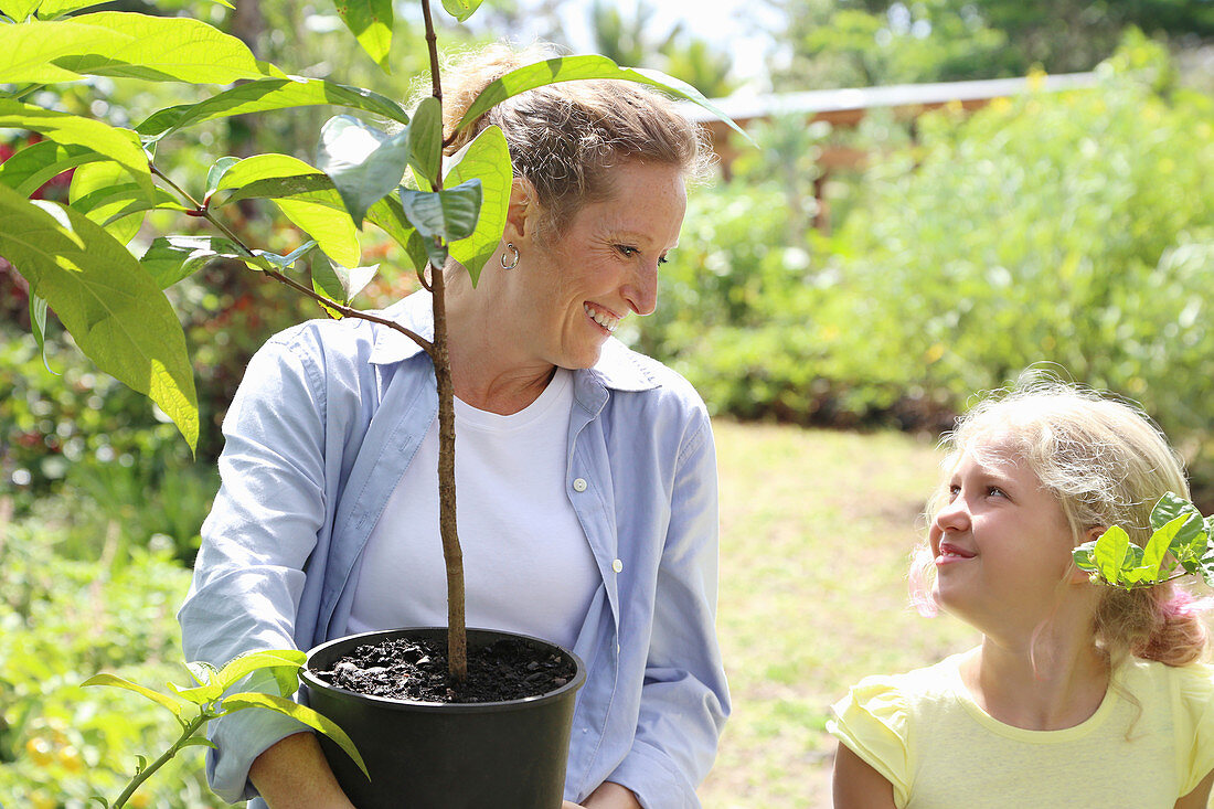 Woman and girl with tree seedling