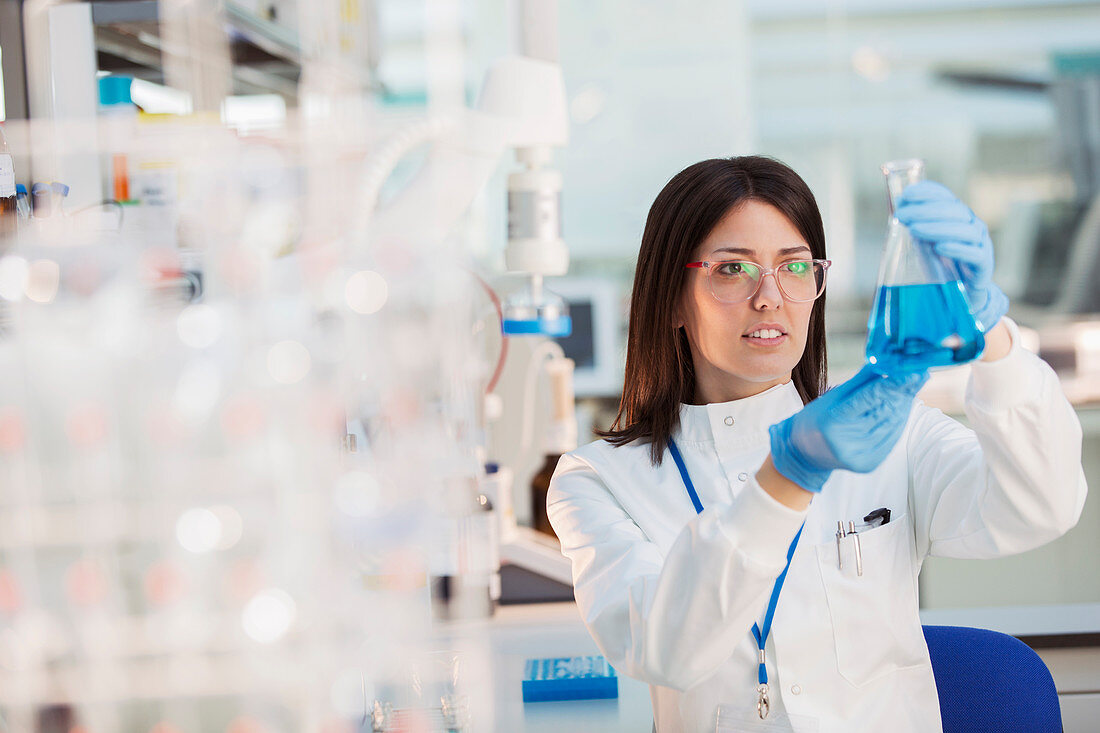 Scientist examining sample in beaker