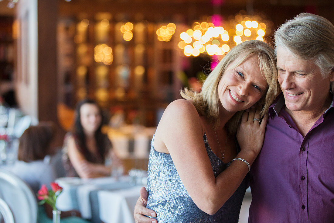 Man embracing woman in restaurant