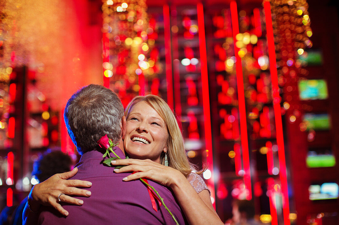 Woman and man embracing in nightclub
