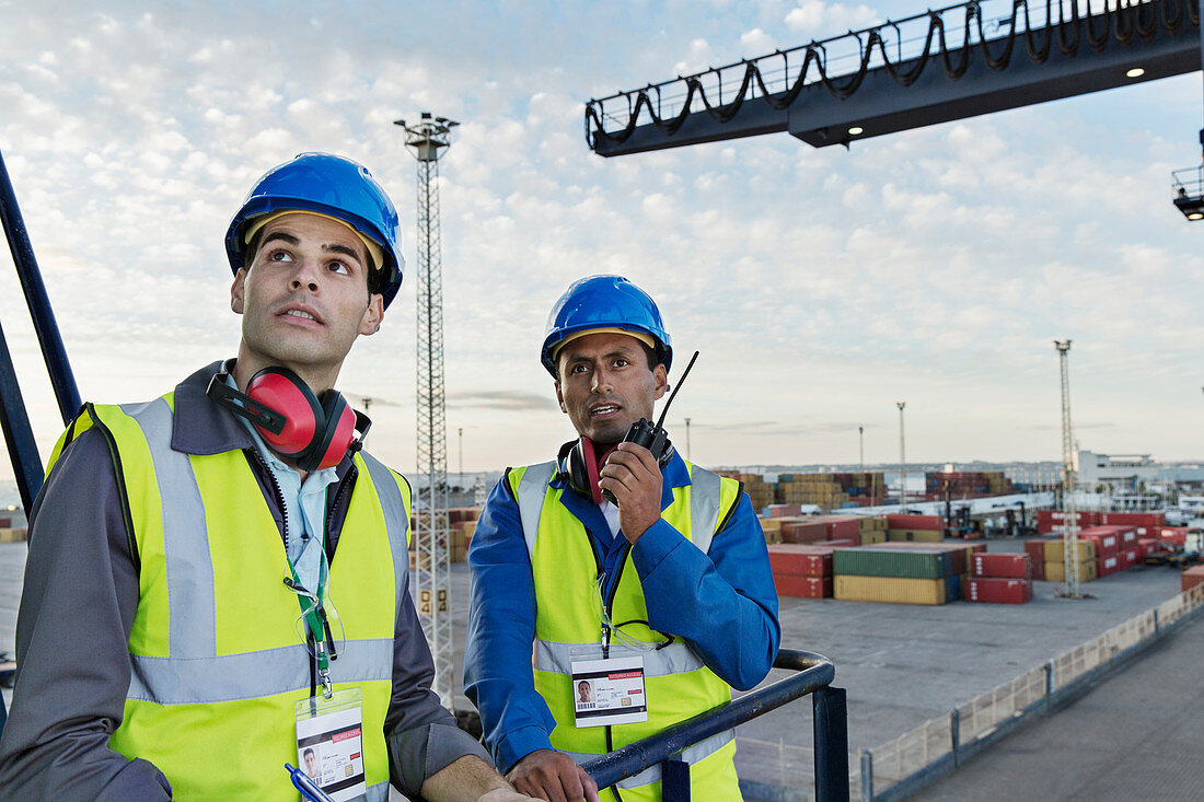 Workers standing on cargo crane