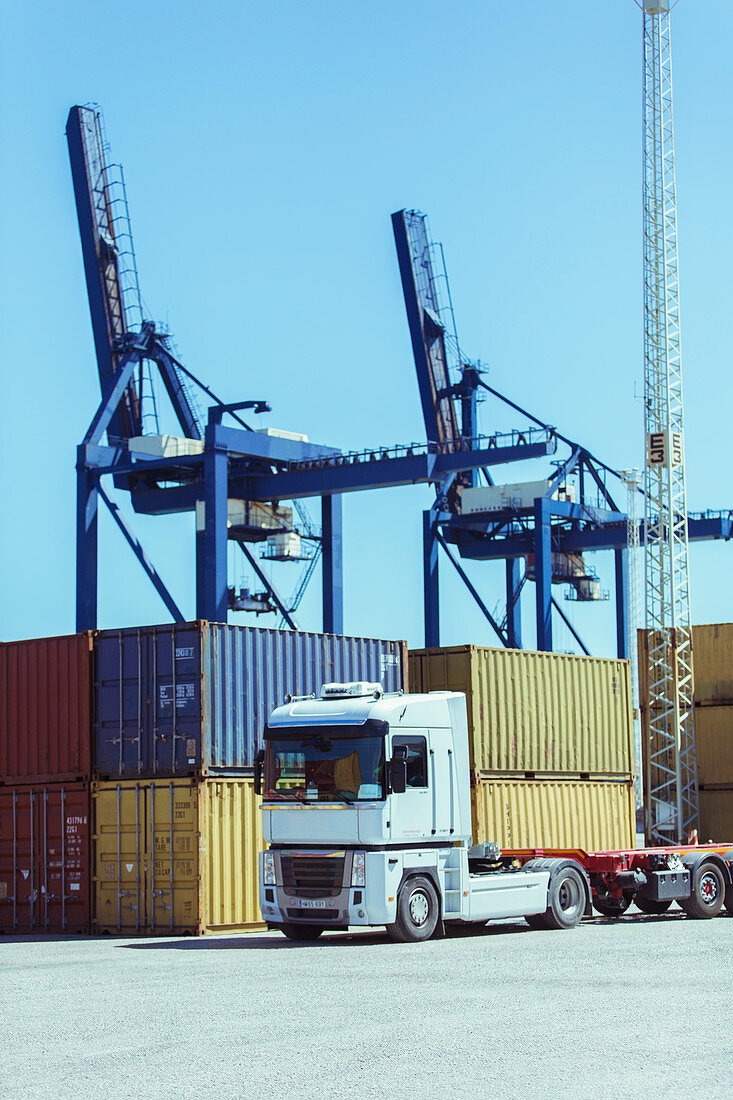 Cranes over cargo containers and truck