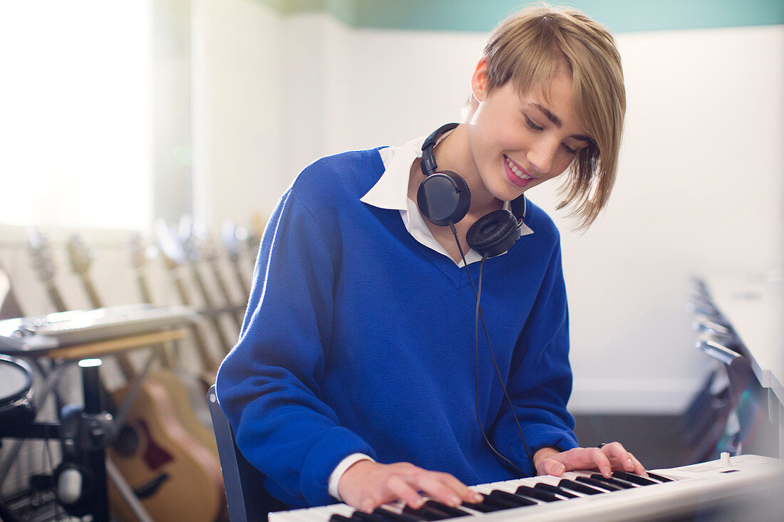 Student playing synthesizer