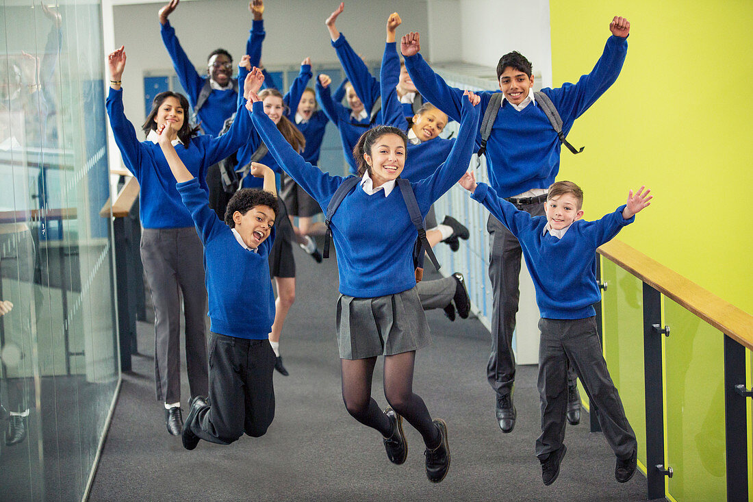 Students smiling and jumping