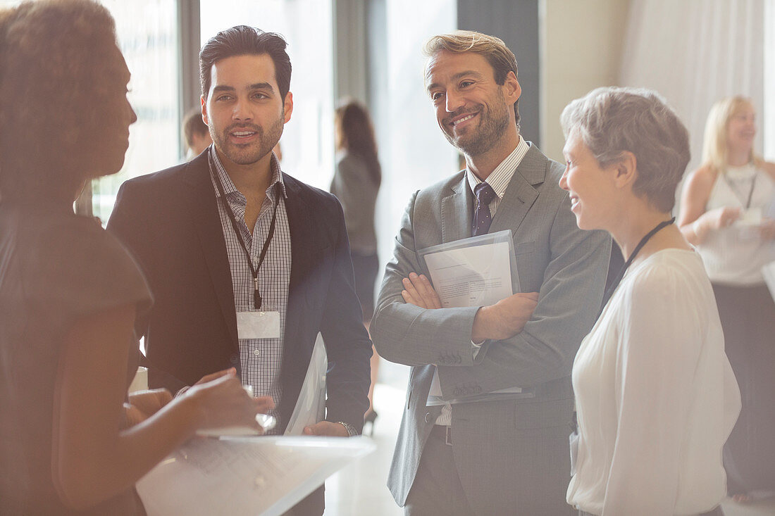 Business people smiling and discussing