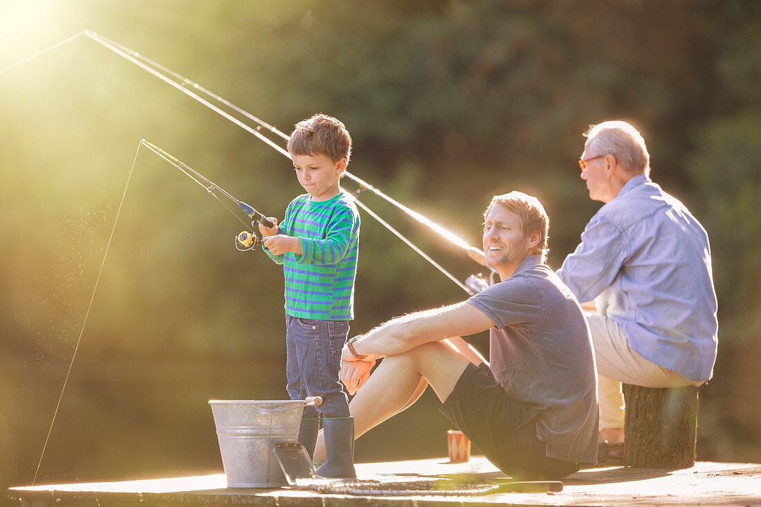 Boy, father and grandfather fishing