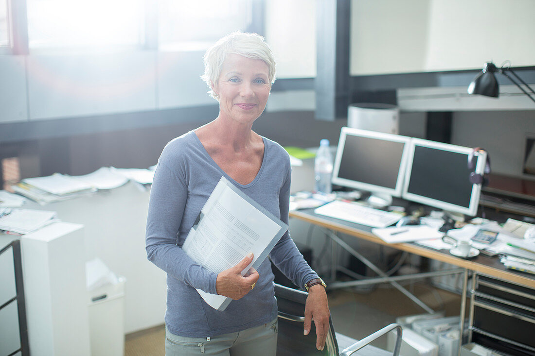 Businesswoman carrying paperwork