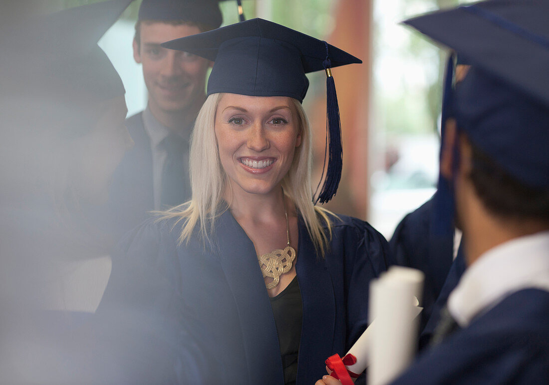 Student smiling in graduation clothes