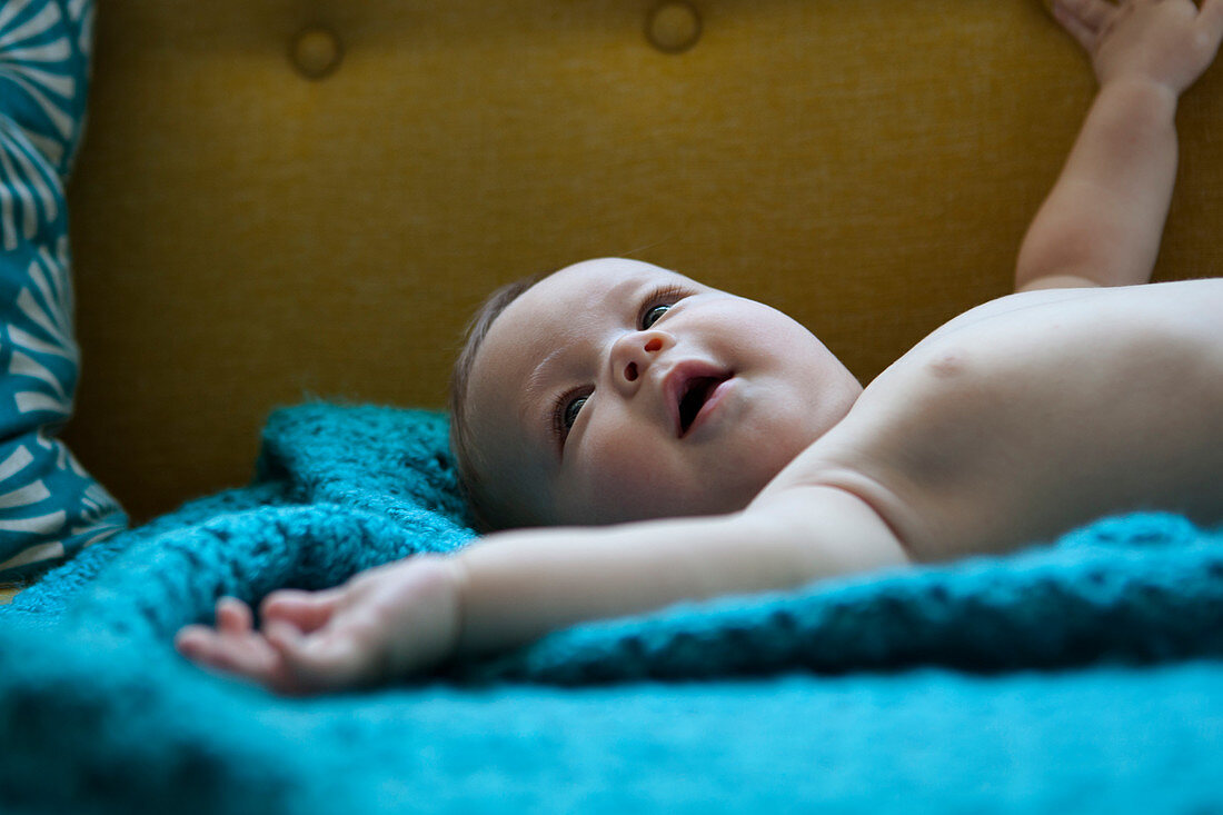 Baby lying on blue cloth