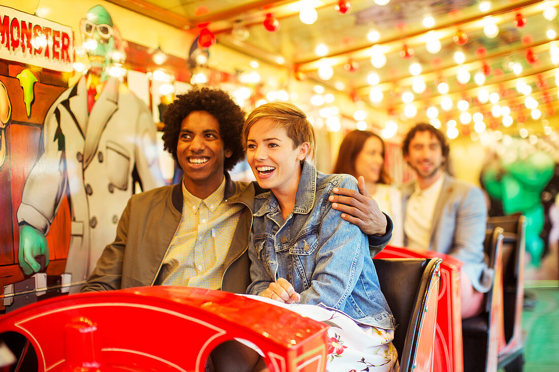 Man embracing girlfriend on ghost train