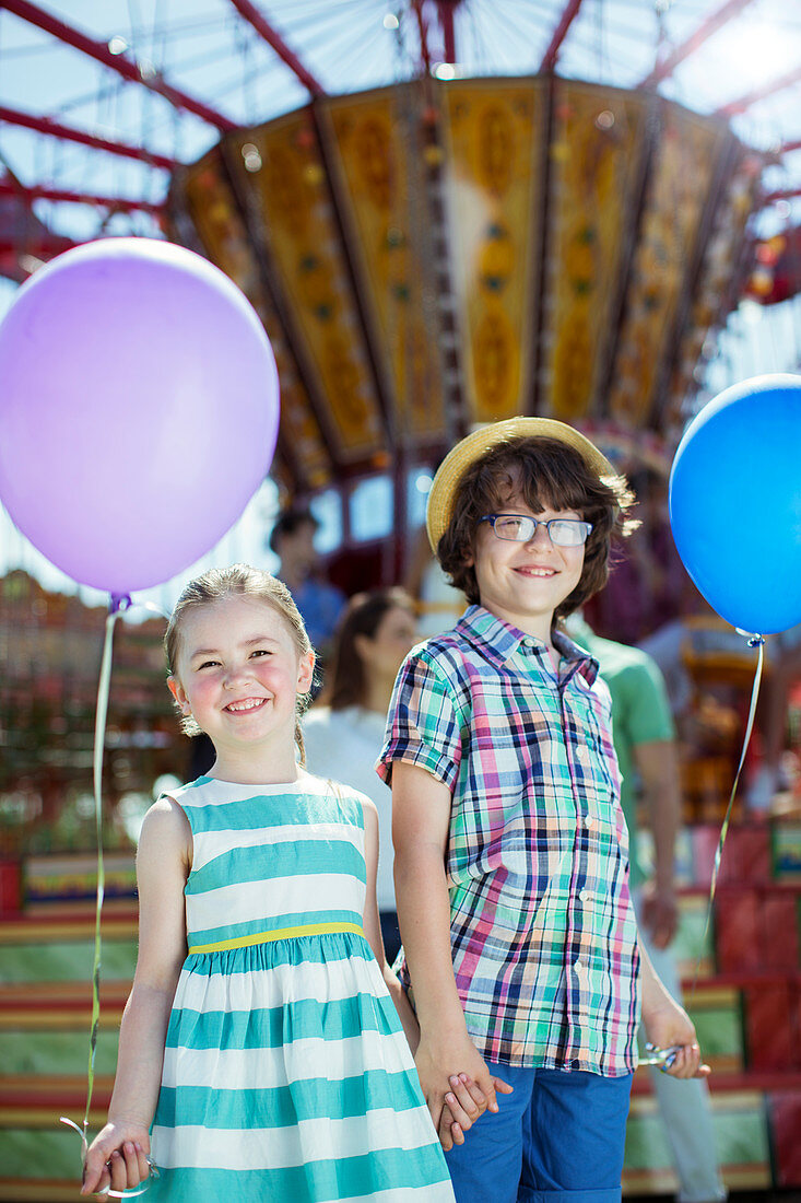 Boy and girl holding balloons
