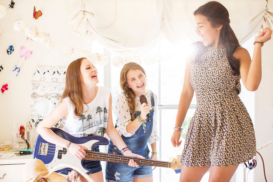 Girls playing music and singing in room