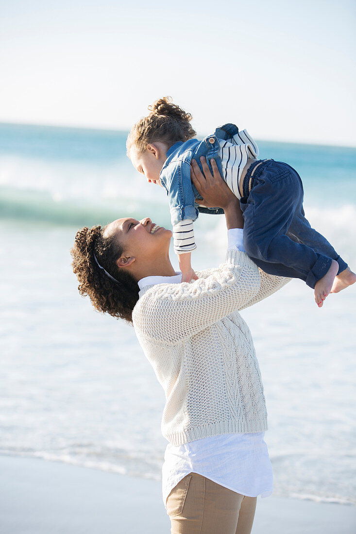 Mother and daughter playing on beach