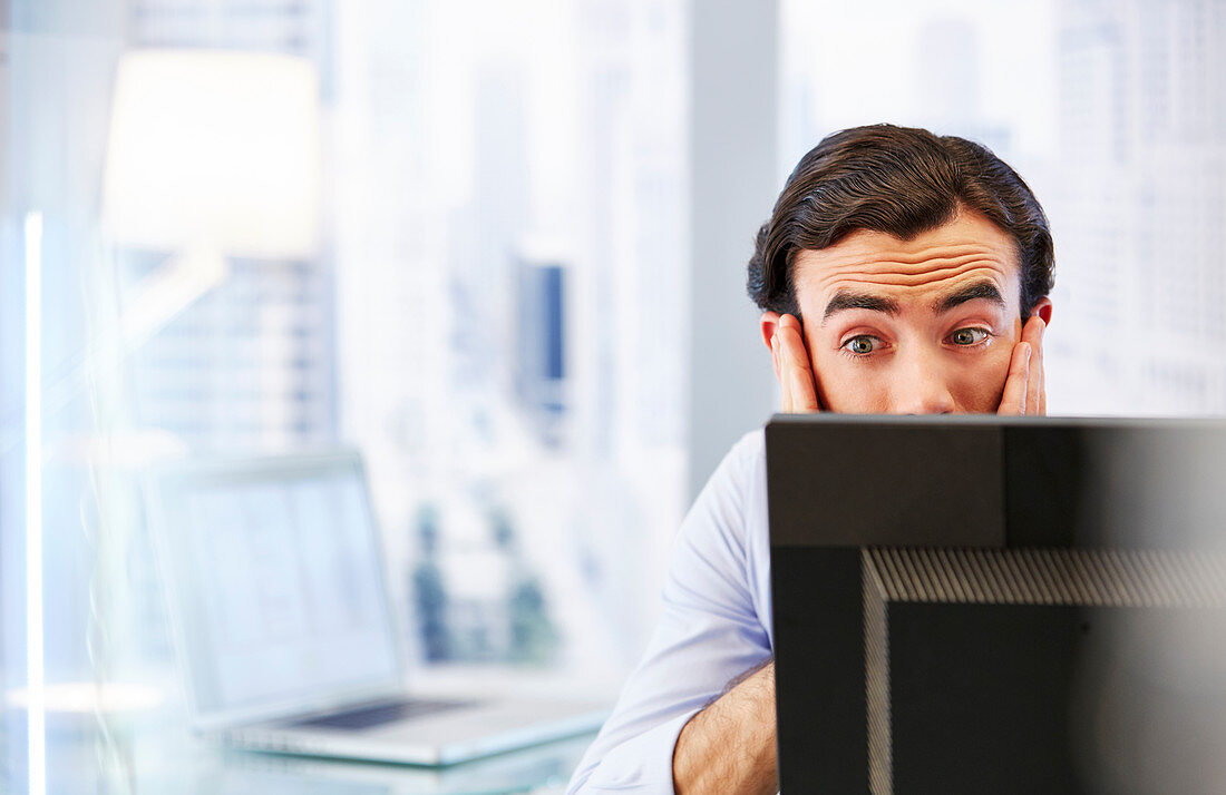 Man using computer, stressed and worried