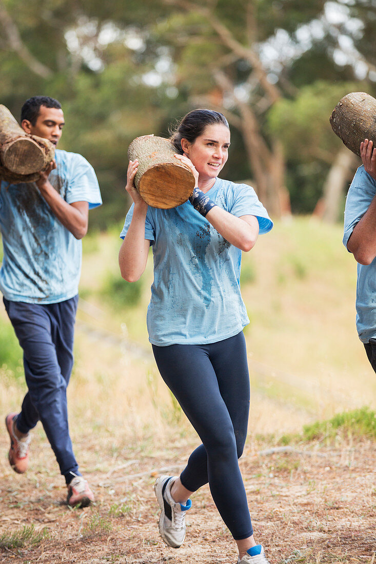 Woman running with log course