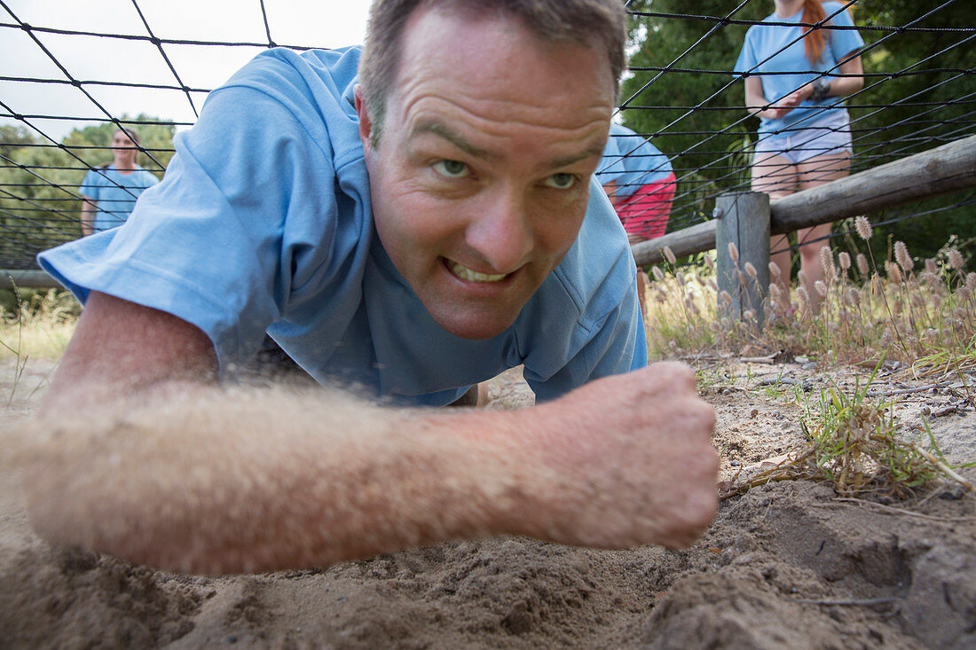 Determined man crawling course