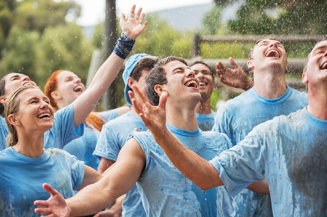 Enthusiastic team enjoying rain