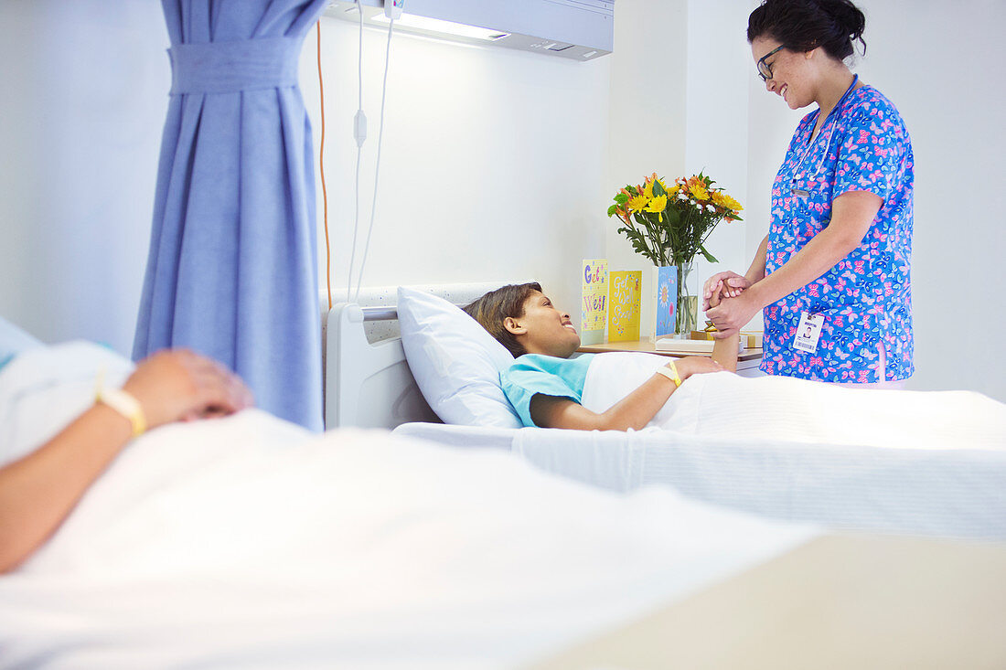 Nurse holding hands with patient