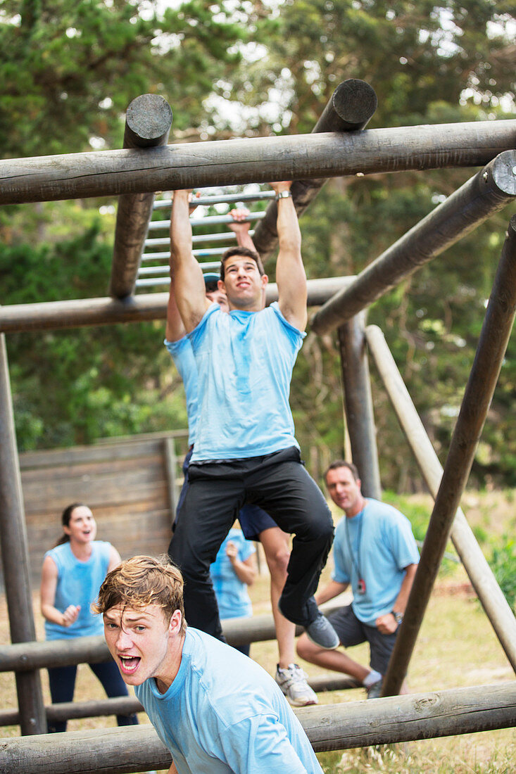 Determined man crossing monkey bars