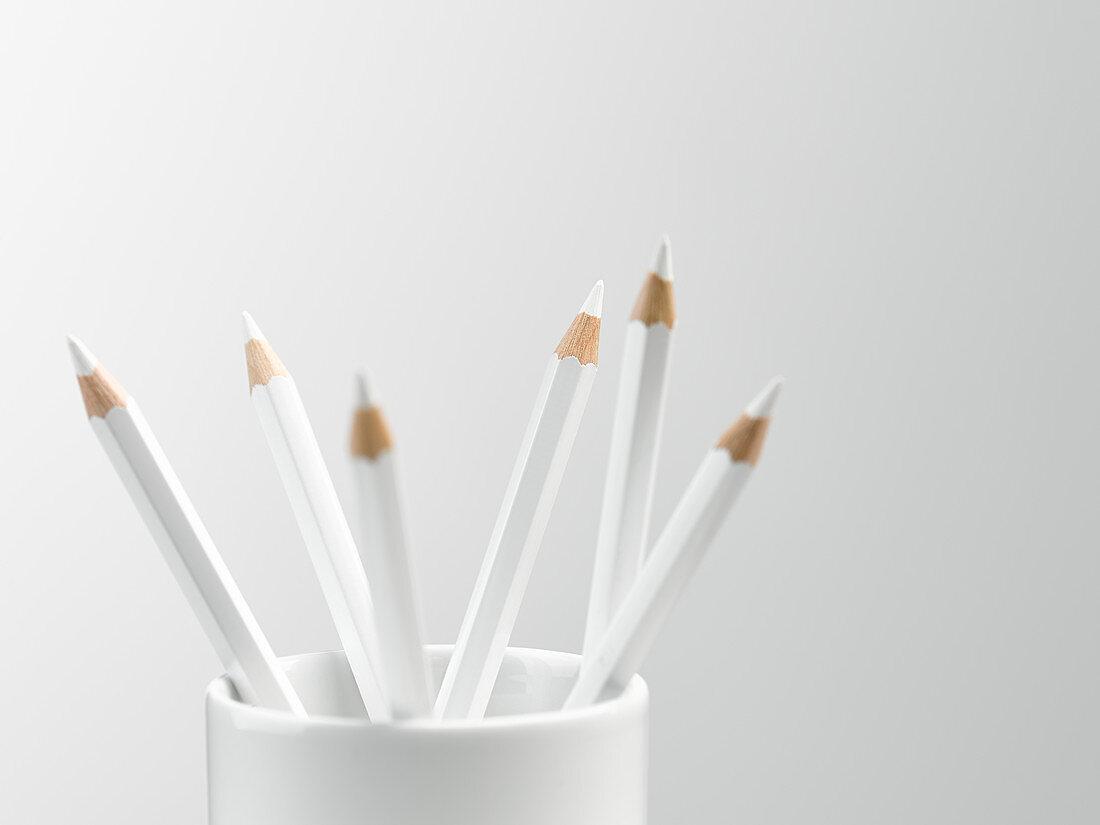 White pencils in white cup still life