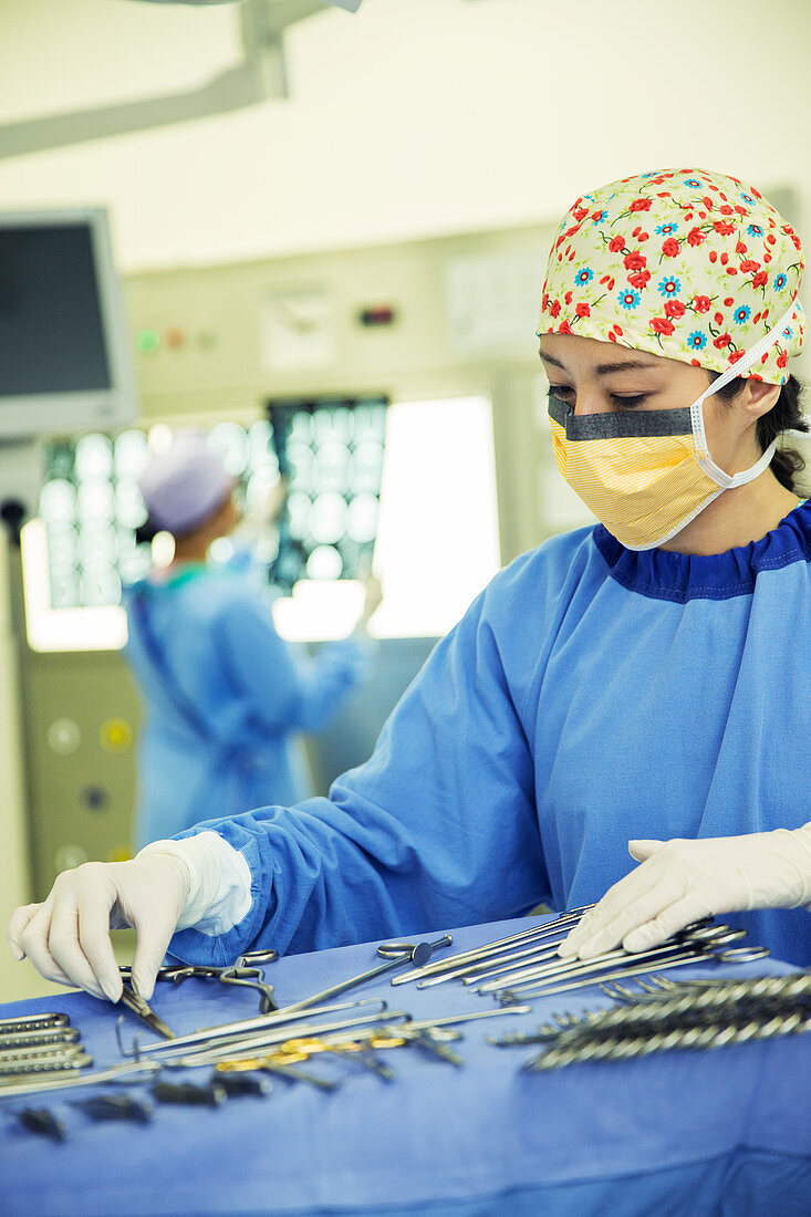 Surgeon arranging surgical scissors