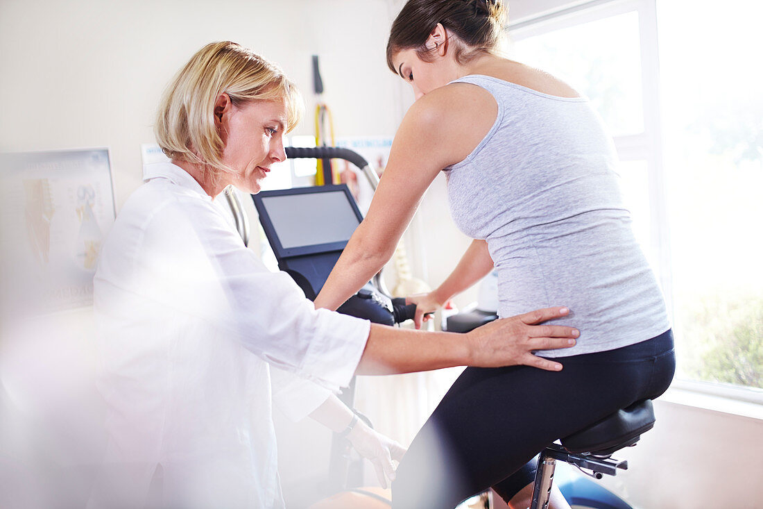 Physical therapist guiding woman