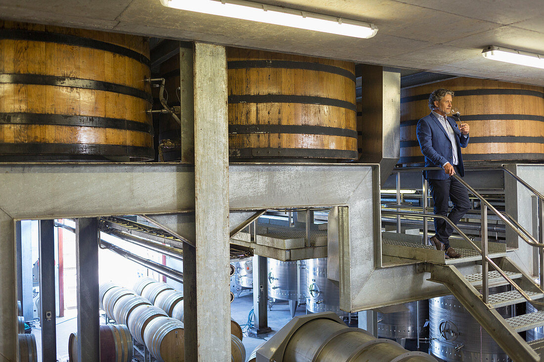 Vintner with red wine on platform