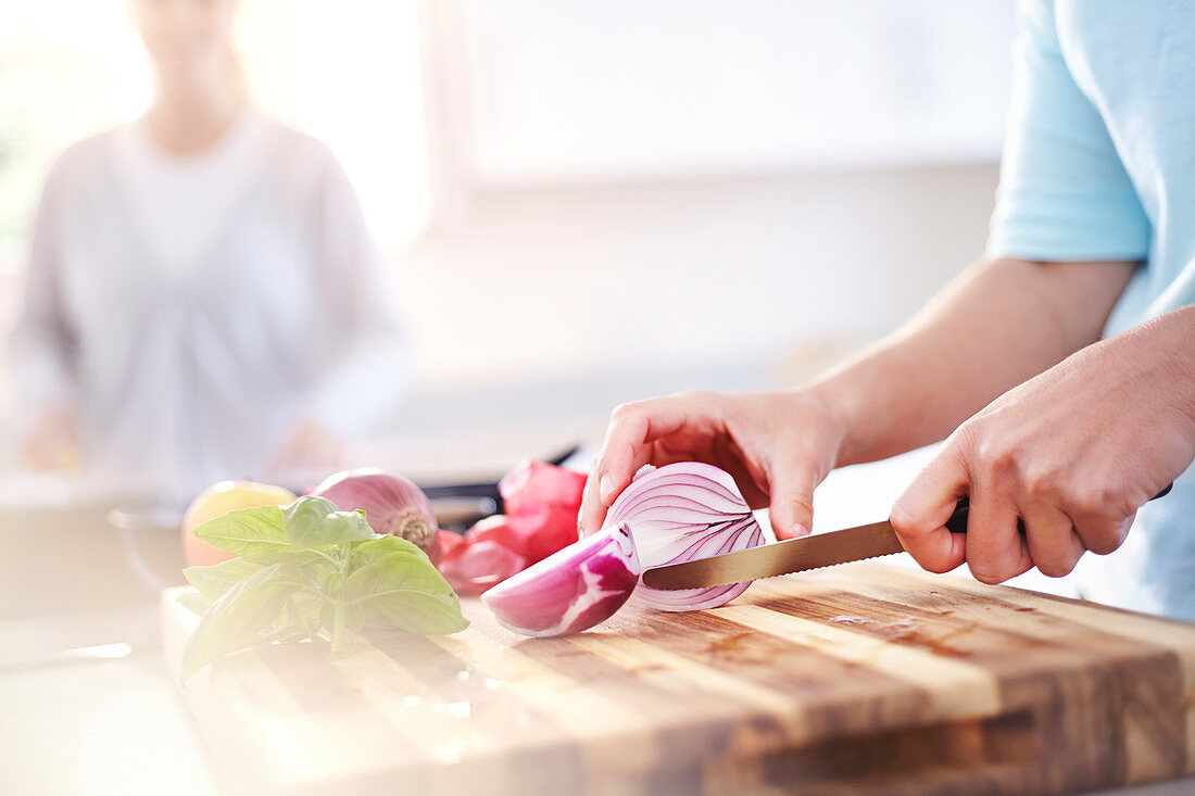 Woman slicing red onion