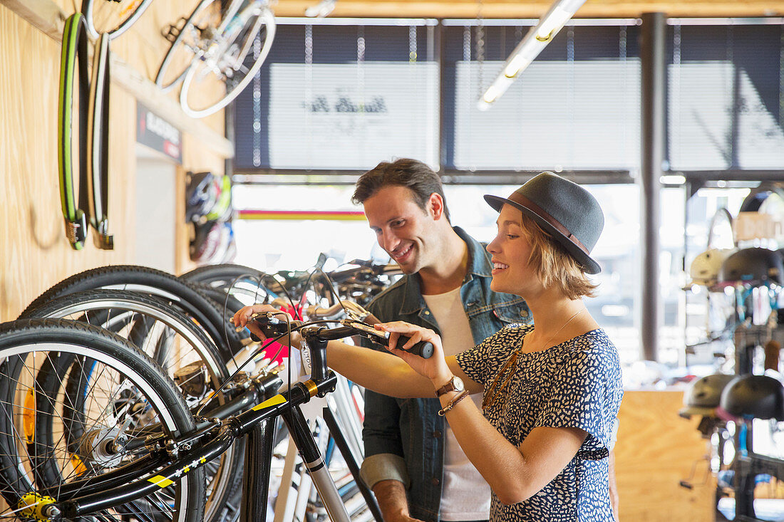 Couple looking at price tags on bicycles