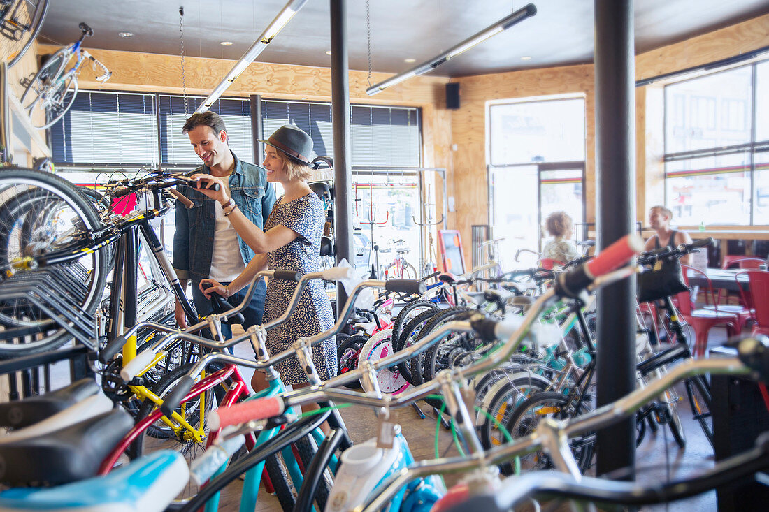 Couple browsing bicycles on rack