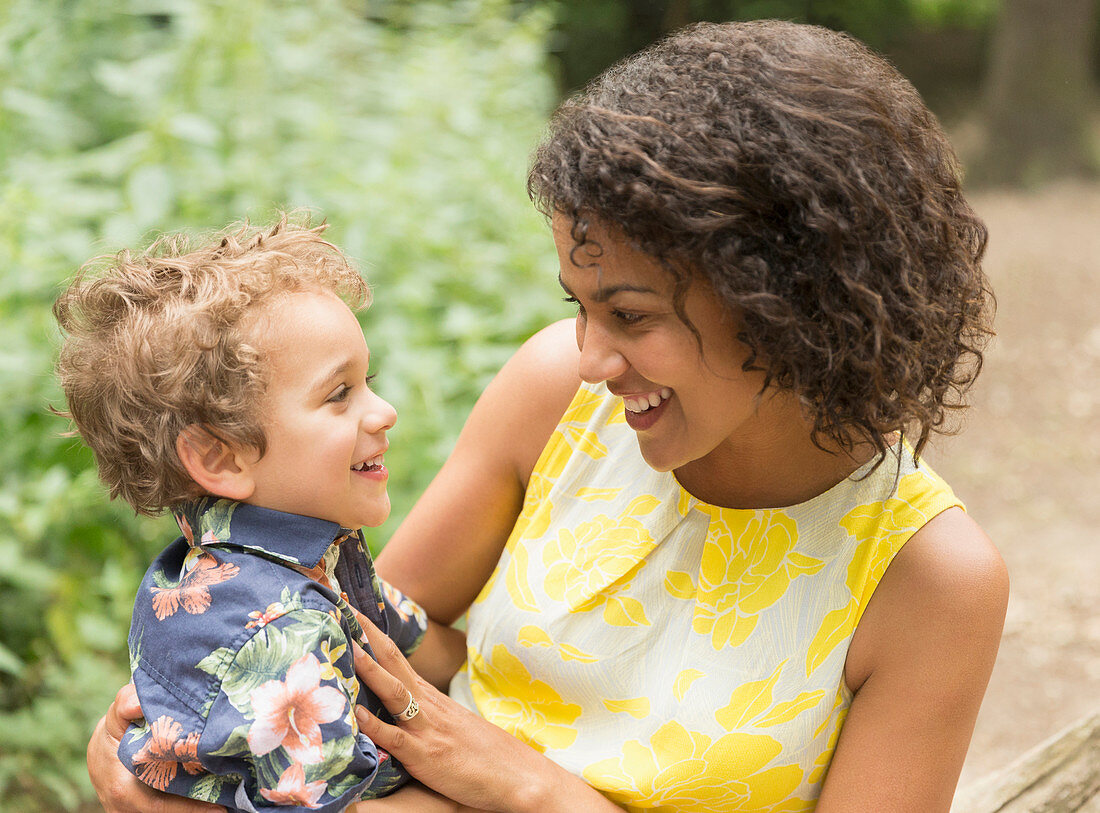 Smiling mother and son face to face