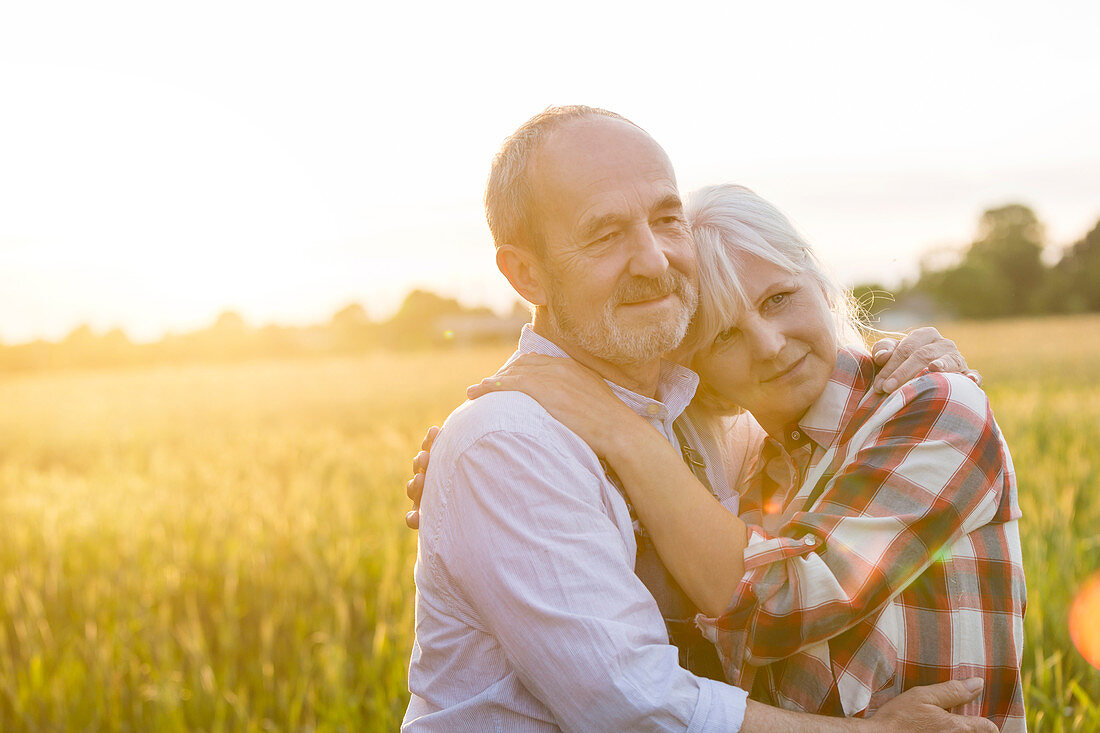 Affectionate serene senior couple hugging