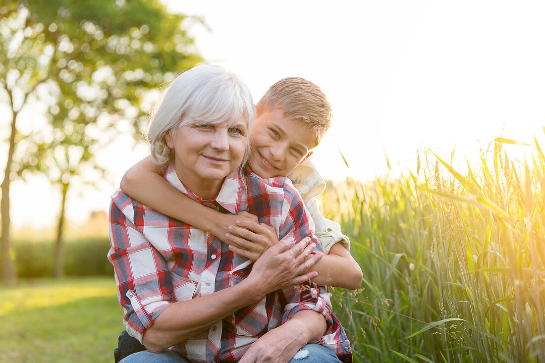 Smiling grandmother and grandson hugging