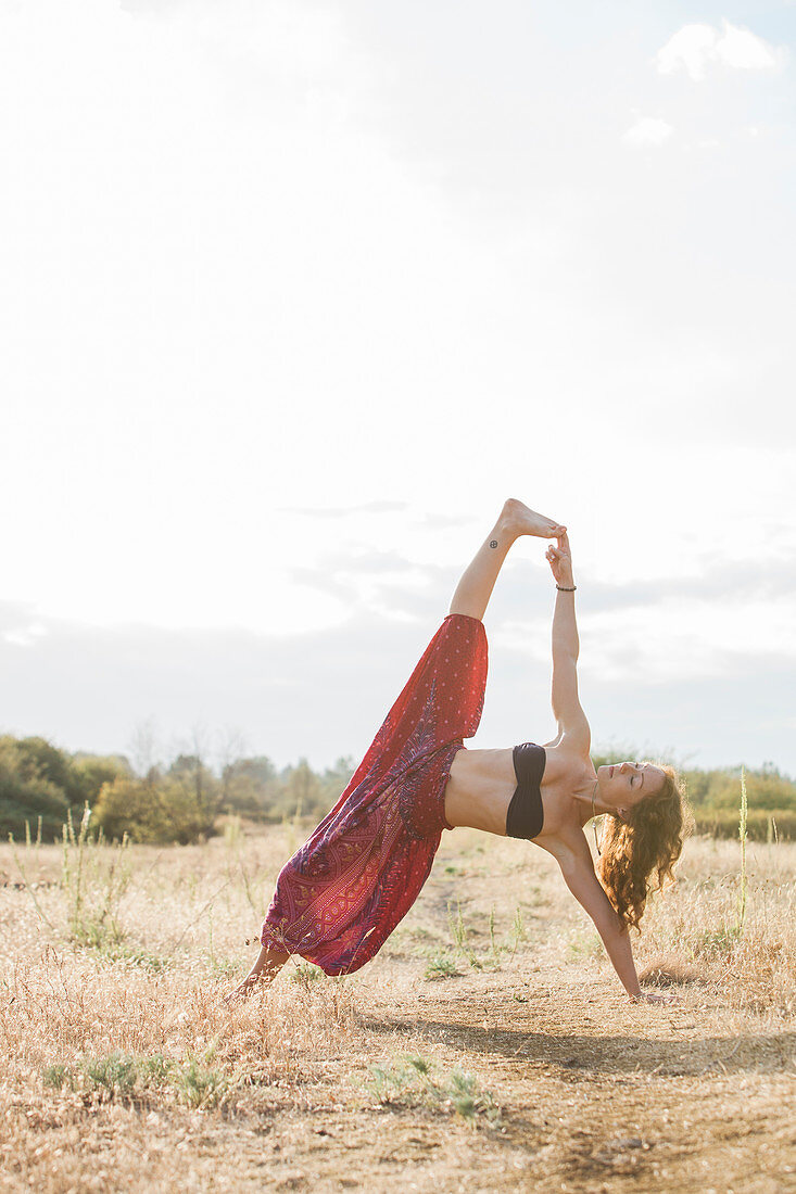 Boho woman in yoga pose