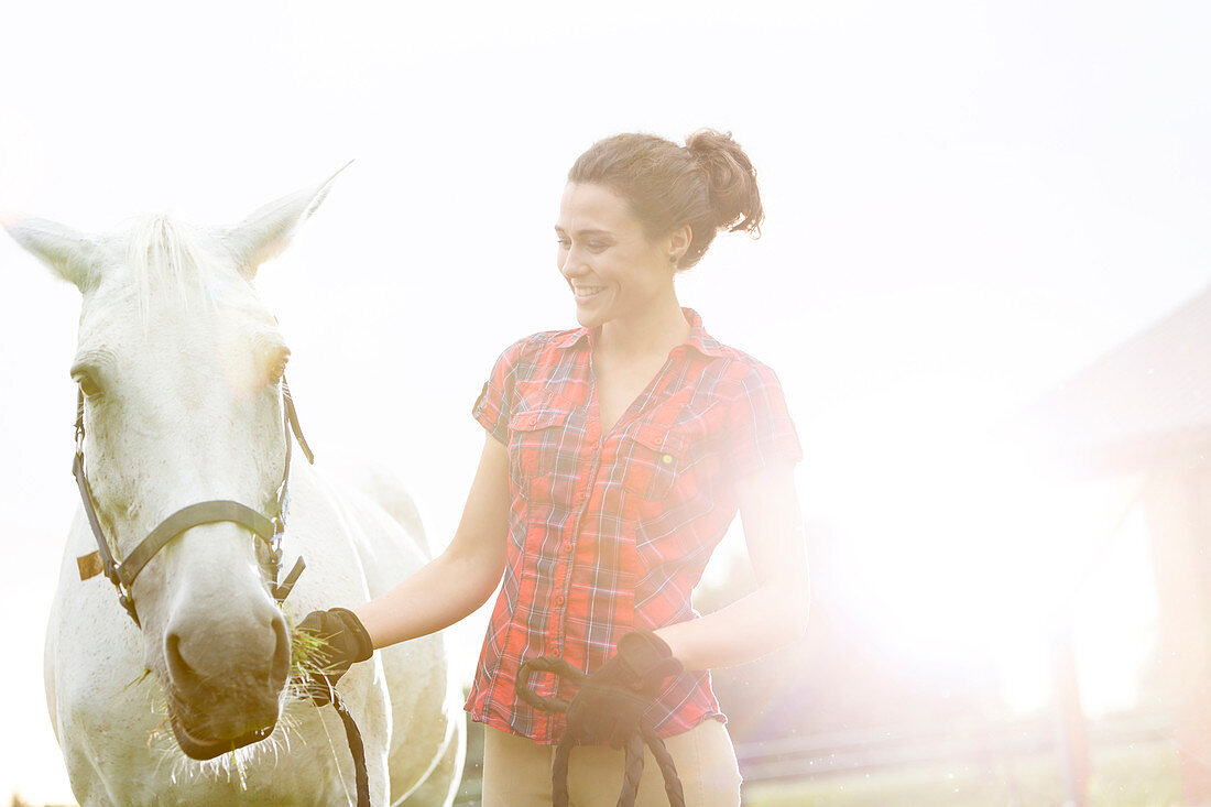 Smiling woman with horse
