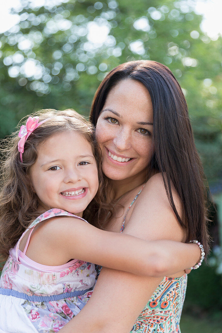 Portrait smiling mother holding daughter