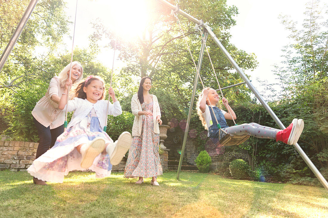 Carefree multi-generation women swinging