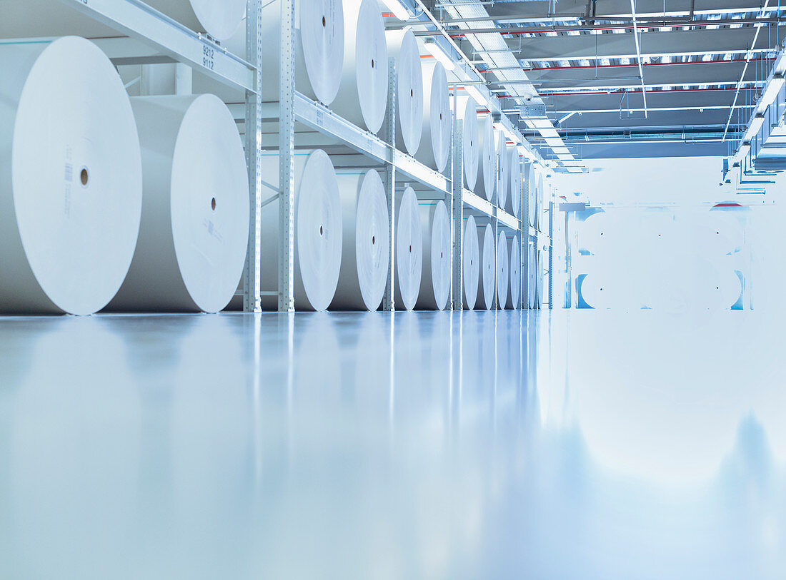 Large spools of paper in printing plant