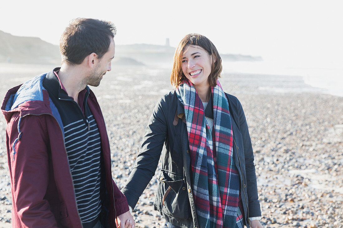 Smiling couple walking on beach