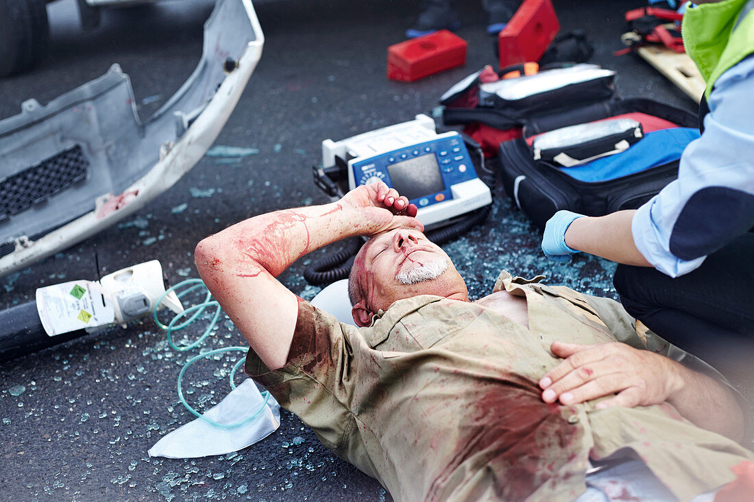 Car accident victim laying in road