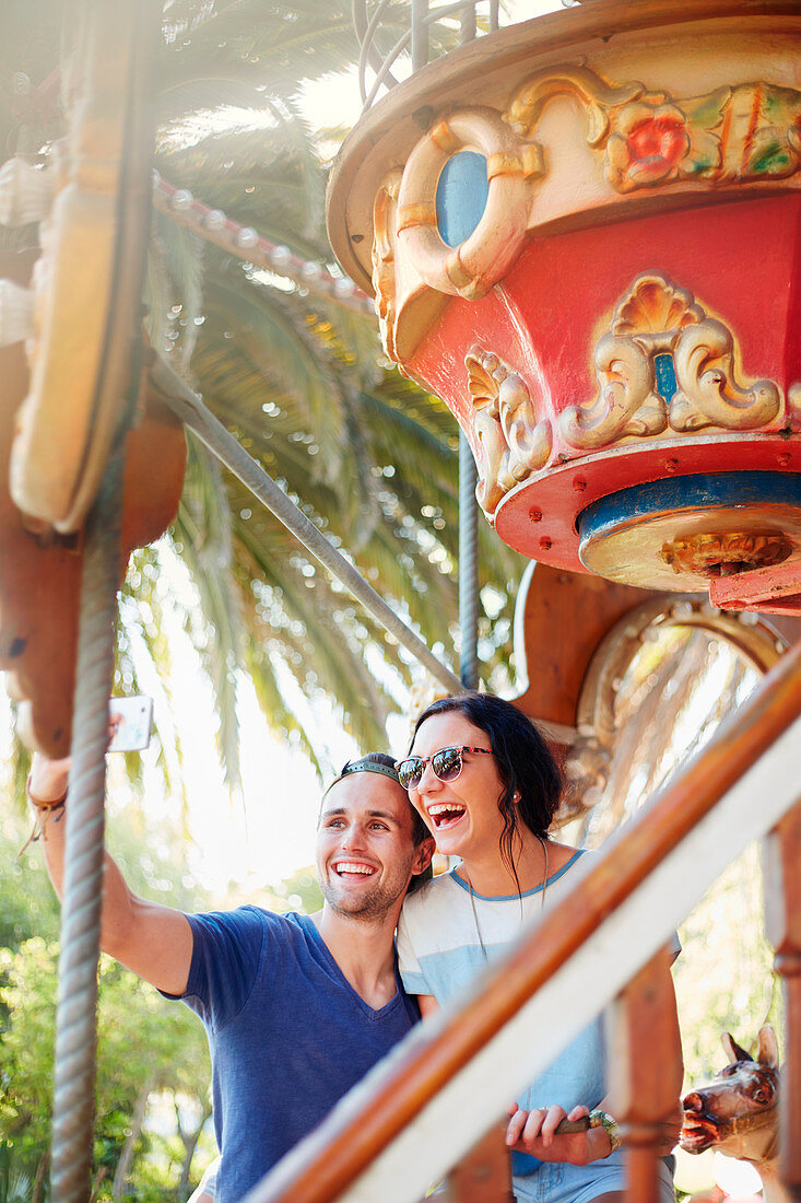 Couple taking selfie at amusement park