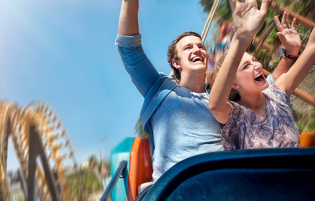 Couple riding amusement park ride