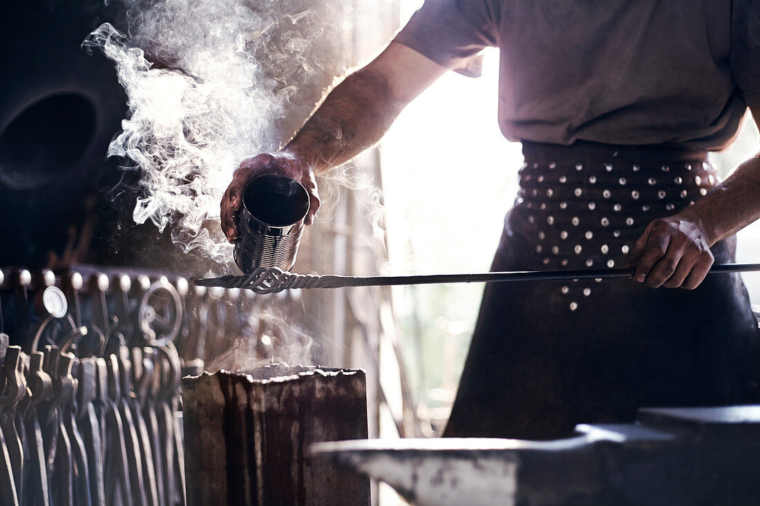 Blacksmith pouring hot liquid