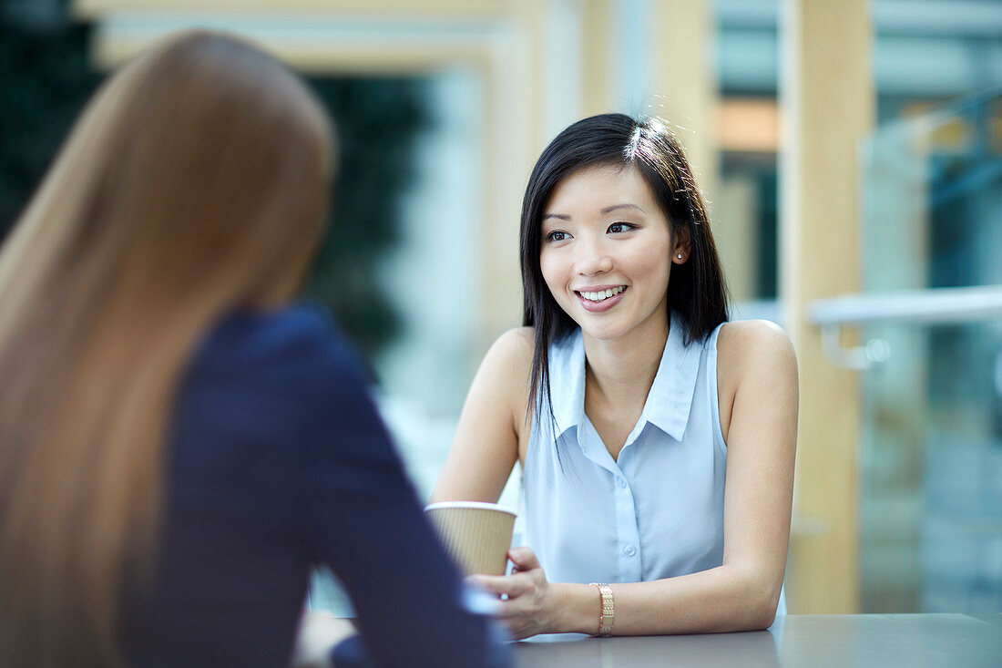 Businesswomen talking on coffee break