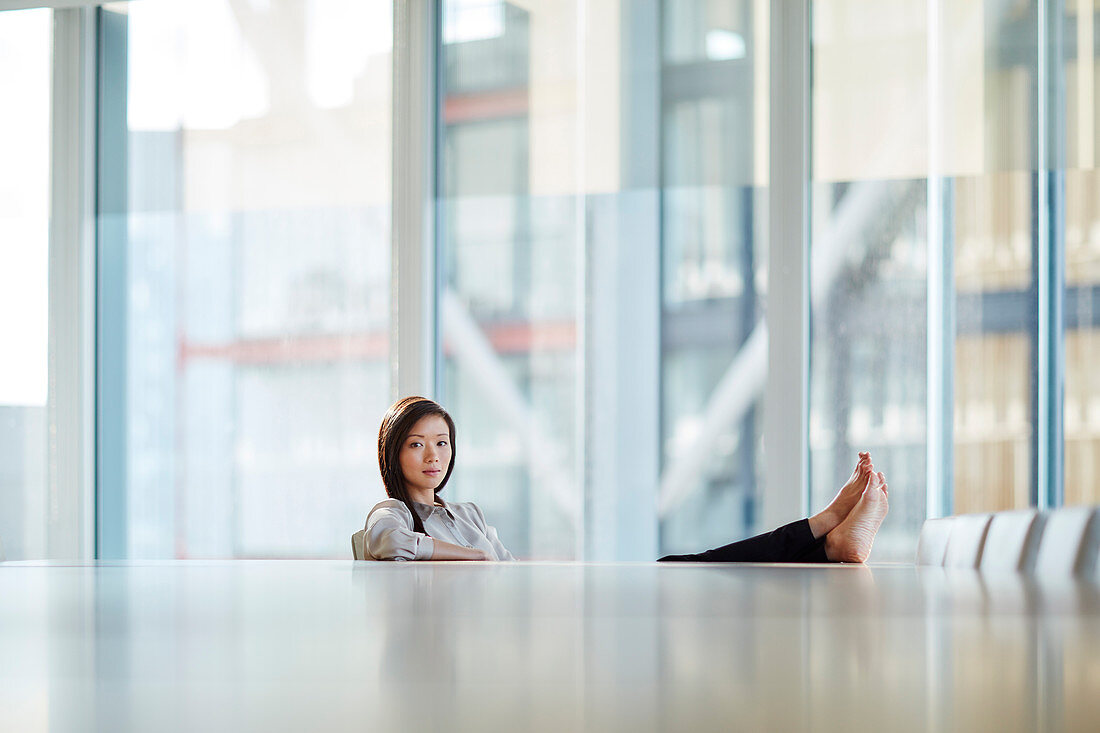 Businesswoman with feet on table