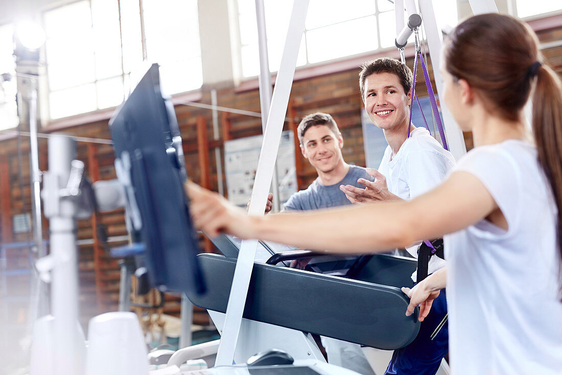Physical therapists with man on treadmill