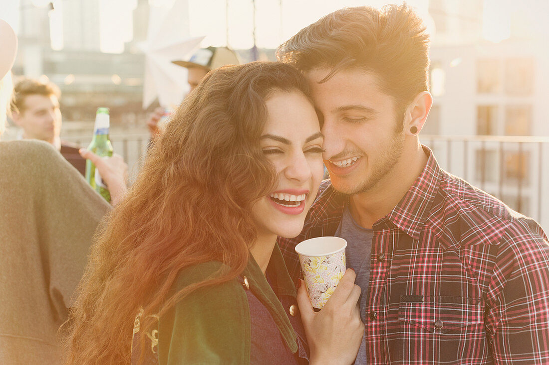 Laughing young couple hugging